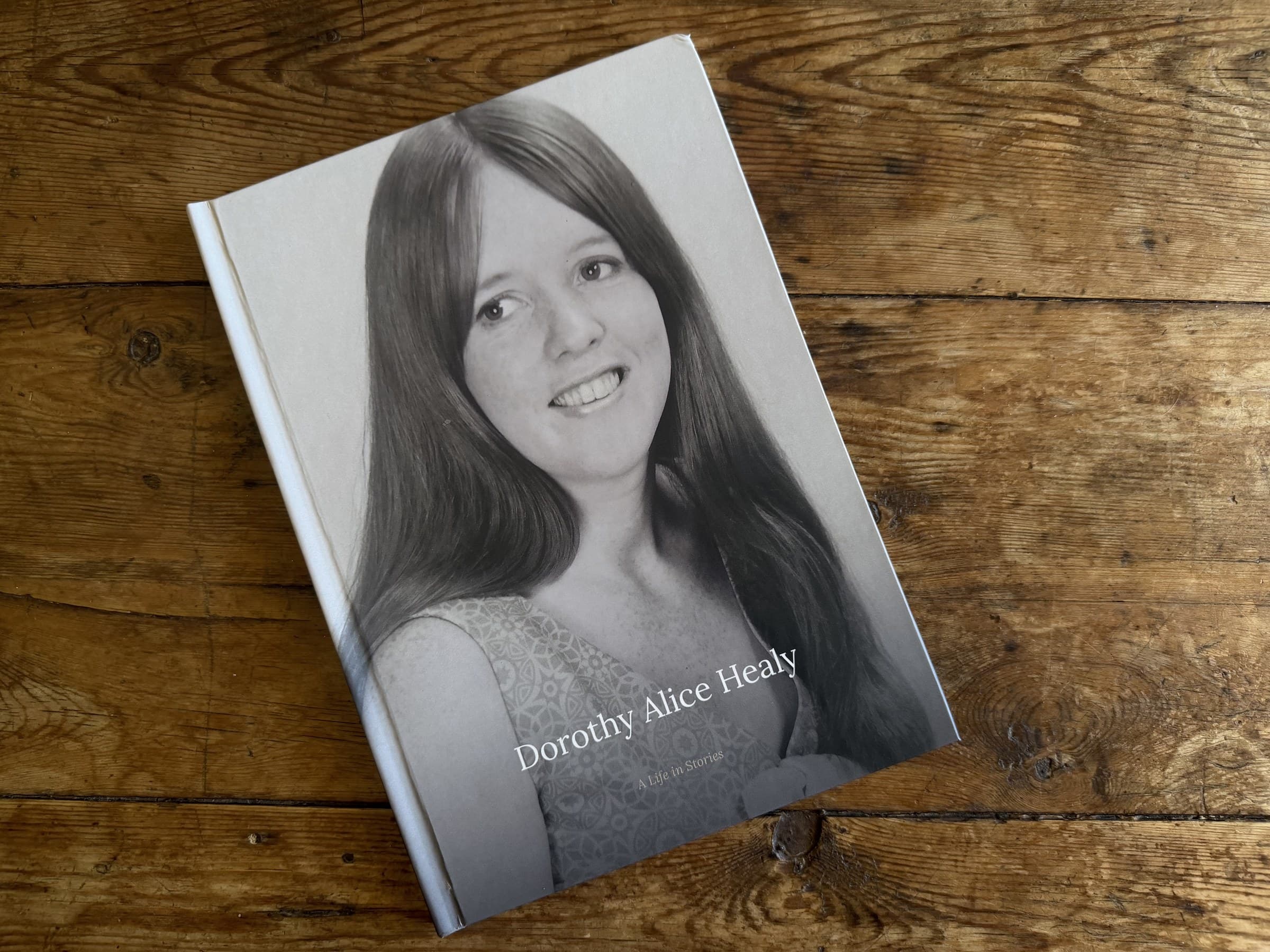 A printed LifeLoom book on a timber table: Dorothy Alice Healy, A Life in Stories